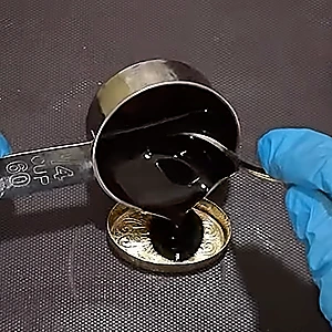 Pouring the finished eyebrow gel in a container of your choice