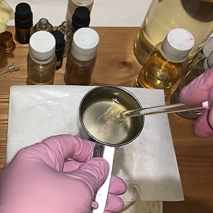 Mixing the almond oil and the three fragrance oils