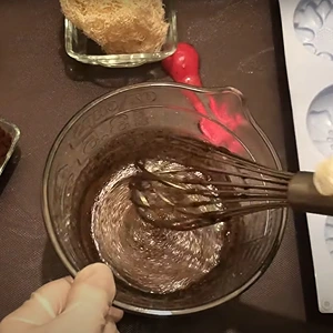 Mixing the contents with a whisk