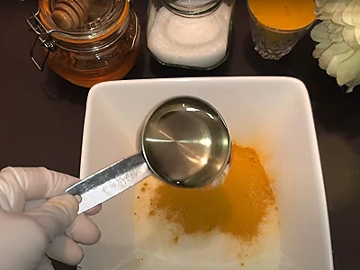 DIY turmeric face scrub. Adding almond oil