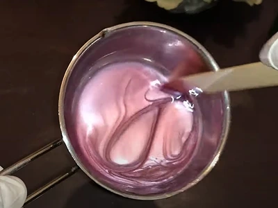 DIY Easy and Natural Lip Balm. Mixing the purple mica color with the remaining mix