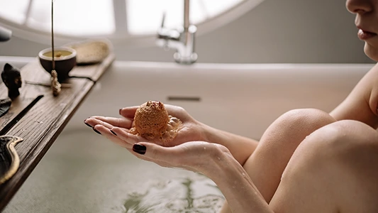 DIY Musk Bath Bomb. Woman in bathtub with bath bomb
