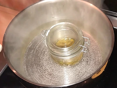 DIY Lemon Peel Carrier Oil. The container is in a bain-marie