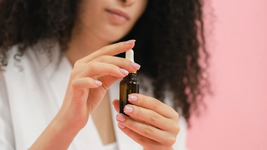 DIY Natural Serum for Oily Skin. Woman holding serum bottle