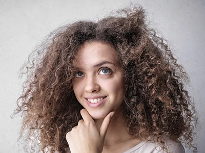 DIY Oat Milk Hair Cream. Woman with unruly hair