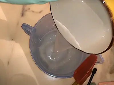DIY Light Body Lotion. Pour the water phase mixture over the oil phase mixture