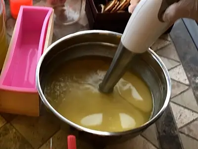 DIY Orange Cold Process Soap. Alternate mixing with the electric mixer and the spatula