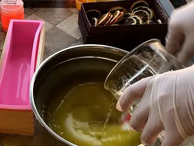 DIY Orange Cold Process Soap. Pour the sodium hydroxide solution into the oils while stirring